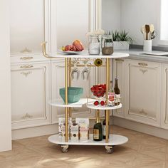 a white and gold bar cart in a kitchen