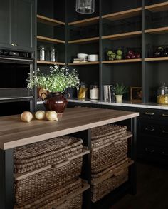 a kitchen with black cabinets and wooden counter tops