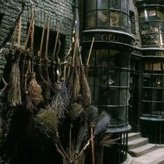 there are many brooms hanging on the outside of this building in harry potter's studio