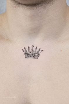 a man's chest with a crown tattoo on his left side ribcage