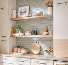 the kitchen is clean and ready to be used for cooking or baking, with dishes on the shelves