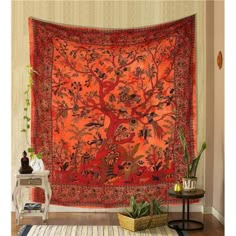 an orange tapestry hanging on the wall in a living room