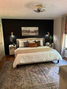 a large bed sitting in the middle of a bedroom