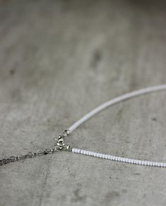 This beautiful dainty choker necklace was made of white seed beads, tiny peach pink crystal beads, one pearl coated glass 10 mm bead, stainless steel separators, silver tone base clasps, strong nylon double thread, silver tone lobster claw and stainless steel adjustable length chain. Perfect jewelry for the summer, especially like a beach necklace! The length of necklace is 41 cm or about 16.1 inches and 4.5 cm of adjustable length chain. Other necklaces you can find in my store in the necklace Simple Short Necklace, Three Pearl Necklace, White Pearl Choker, Cat Charm Necklace, Pearl Bead Necklace, Anchor Jewelry, Dainty Choker Necklace, White Choker, Beads Choker