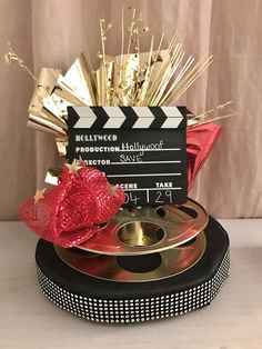 a movie clapper and some gold objects on a table