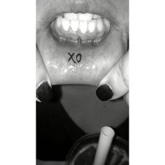 a woman holding her mouth open with the word x on it