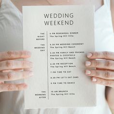 a woman holding up a wedding weekend program