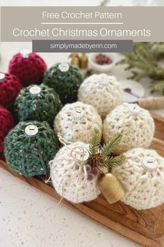 crochet christmas ornaments on a wooden tray with pine cones and needles in the center