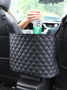 a woman holding a bottle in her car seat with the back pocket full of water