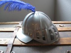 a helmet with a blue feather on it