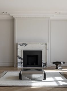 a living room with a fireplace and white walls