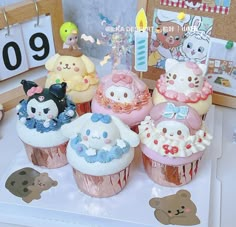 there are many cupcakes that are on the table with decorations around them,