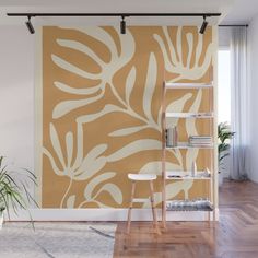 an orange and white wall mural in a living room with wooden flooring, bookshelf and plant