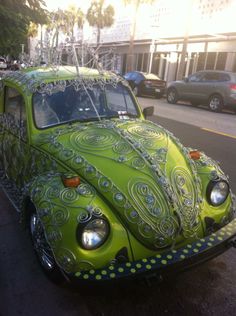 a green vw bug painted to look like an octopus