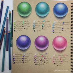 an open notebook with colored pencils next to it and several different types of balls