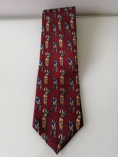 "VTG-Lord Taylor Golf NeckTie, Kensington Collection 100% Italian Silk,Burgundy Red, Wedding Accessories, Gift for Him, Men's Golf Tie,Golfer Introducing the VTG-Lord Taylor Golf NeckTie from the Kensington Collection! Crafted with utmost precision and style, this tie is a true masterpiece for any dapper gentleman. Made from 100% Italian Silk in a rich Burgundy Red hue, it exudes sophistication and luxury, making it an ideal choice for weddings and other formal occasions. Whether you're a golfer looking to elevate your style on the greens or searching for a thoughtful gift for the golf enthusiast in your life, this Men's Golf Tie is the perfect choice. Elevate your fashion game and make a statement with this exquisite accessory - the VTG-Lord Taylor Golf NeckTie. Measurements: Length: Appr Burgundy Red Wedding, Ron White, Funky Necklace, Girls Tulle Dress, Christmas Ties, Dapper Gentleman, Antique Bracelets, Rich Burgundy, Tutus For Girls