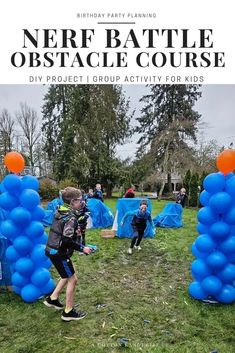 some kids are playing with blue balloons in the grass