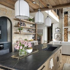 a large kitchen with an island in the middle and lots of shelves on the wall