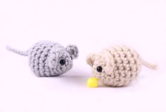 two small crocheted mice with one eating a yellow object