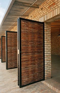 an open wooden door on the side of a brick building