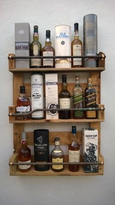 a wooden shelf filled with lots of different types of liquor