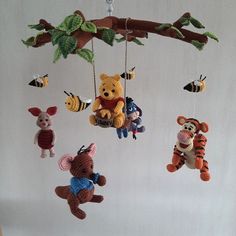 several stuffed animals hanging from a tree branch