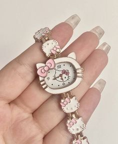 a hello kitty watch is shown on someone's hand