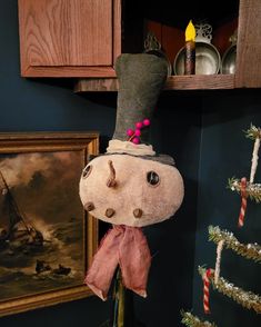 a stuffed animal head hanging from the side of a shelf next to a christmas tree