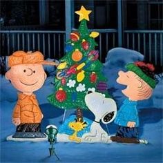 three peanuts around a christmas tree in the snow