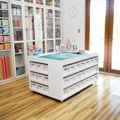 a room with lots of books and craft supplies on the shelves in front of it