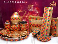 an assortment of colorfully decorated bags and purses on a white tablecloth with lights in the background