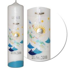 a white candle with blue trim and a cross on it