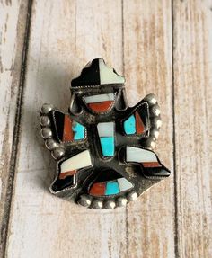 "This is a gorgeous vintage Zuni Knife Wing Pin . It's handcrafted using turquoise, coral, onyx, Mop & bezel set in Sterling silver. It's in excellent pre-owned condition measuring 1.25\"x1\" & 6.84 grams. This beautiful old Kachina Pin is unsigned, as was the case in the 60's & before. It will be a nice addition to any jewelry collection! Please view all photos carefully! Welcome to NorthWestTradingCo." Handmade Bohemian Brooches For Collectors, Unique Handmade Turquoise Brooch, Handmade Vintage Turquoise Brooches, Unique Handmade Turquoise Brooches, Handmade Turquoise Brooches For Collectible, Antique Knife, Vintage Knife, Inlay Jewelry, Antique Oushak Rugs