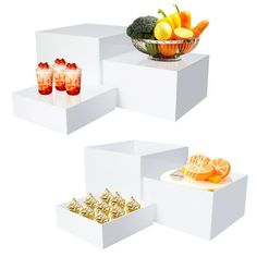 three white boxes with fruit and drinks on them