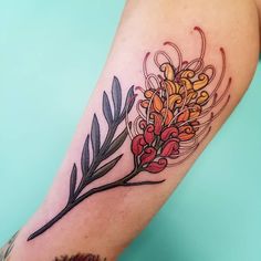 a colorful flower tattoo on the arm