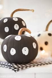 two black and white polka dot pumpkins sitting on a table