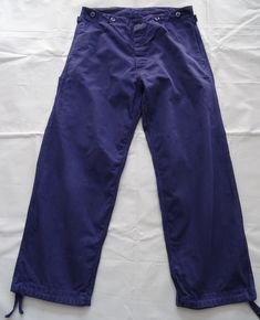 Vintage blue HBT cotton European work pants. No size label on this pair.  Please check the measurements below and go by these in order to establish if these will fit you.   These are originally men's trousers and therefore designed to fit the male form and so they will fit women differently - please check the measurements to avoid disappointment- we no longer accept returns or offer exchanges if an item does not fit.  100% cotton with button fly, side pockets, cinch belt at the back with buckle.