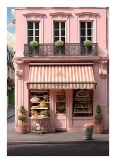 a pink store front with an awning and flower pots in front of the building