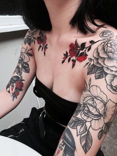 a woman with tattoos on her arm and chest