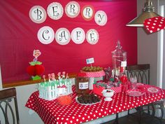 a red and white table topped with lots of desserts