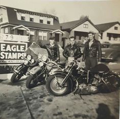 three men standing next to each other on motorcycles in front of a sign that says eagle stamps