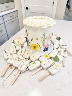 a cake sitting on top of a counter covered in white frosting