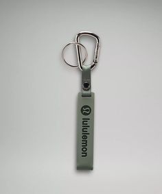 a green key chain with the words london on it