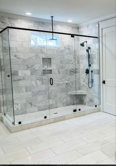 a walk in shower sitting inside of a bathroom