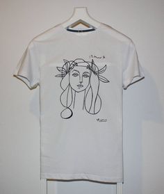 a white t - shirt with a drawing of a woman's face on it