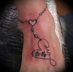 a tattoo on the foot of a person with a dog's paw and heart