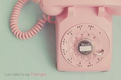 an old pink phone is sitting on the table