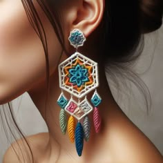 a close up of a woman's face wearing earrings with beads and feathers on them