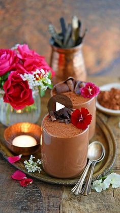 two glasses filled with chocolate pudding and flowers