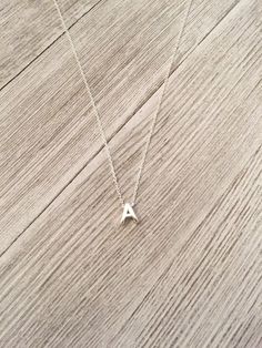 "A lovely, delicate Sterling Silver Necklace in 16 or 18 inches. A simple, beautiful necklace that you could wear everyday! Sterling silver letter pendant with sterling silver chain. Some initials make this a \"Floating\" necklace. PLEASE READ: The letters A,B, D, H, I, J, K, L, M, N, O, P, R and W all have holes in the letters for the chain The letters C, E, F, G, S and T have one hole and \"floats\" on the other side... makes a beautiful and delicate look to the necklace. Please let me know if Sterling Silver Initial Necklace, Silver Initial Necklace, Custom Initial Necklace, Mothers Bracelet, Floating Necklace, Mother Jewelry, Stamped Bracelet, Moms Bracelet, Necklace Initial